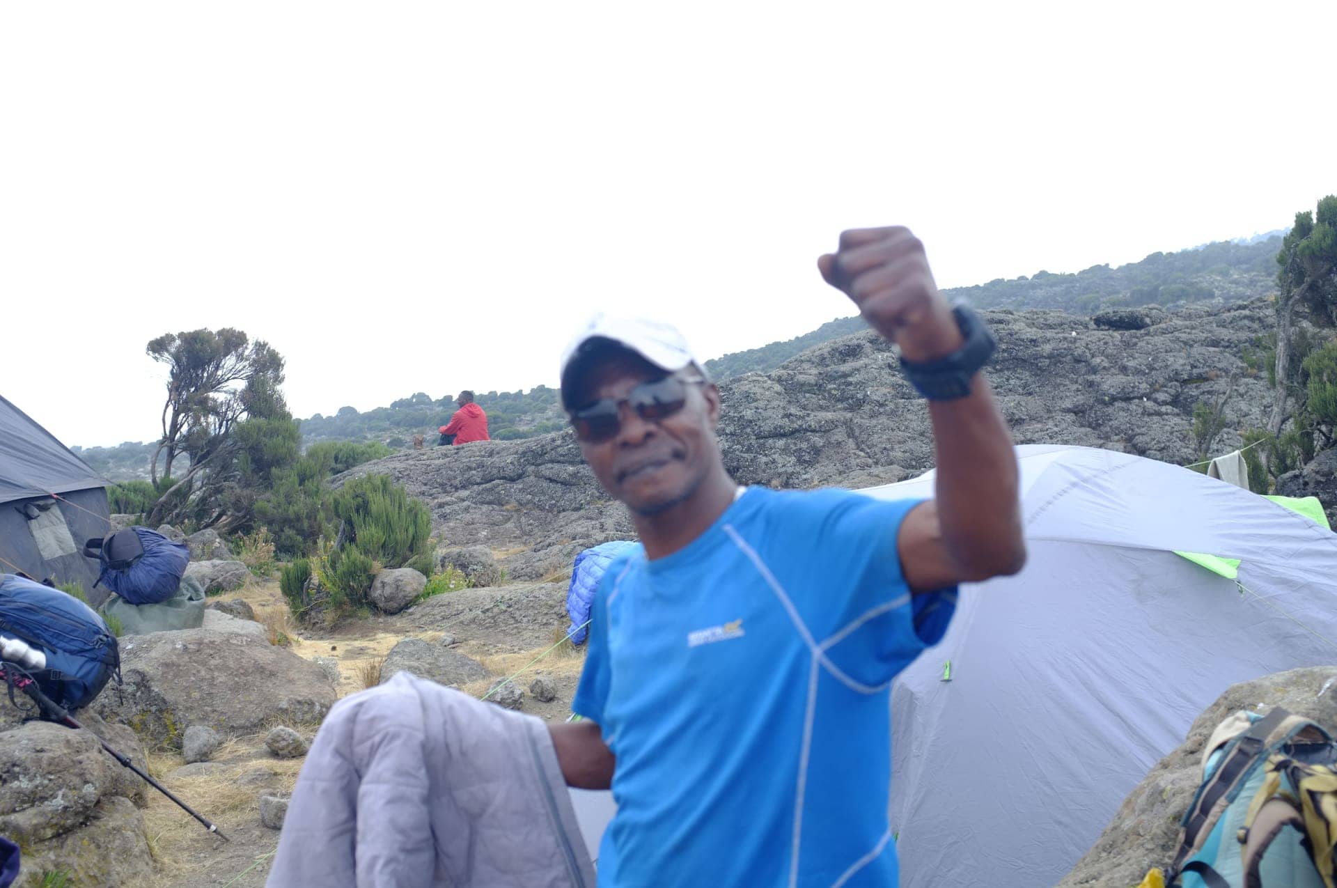A Trust Tours guide celebrating at a Kilimanjaro camp