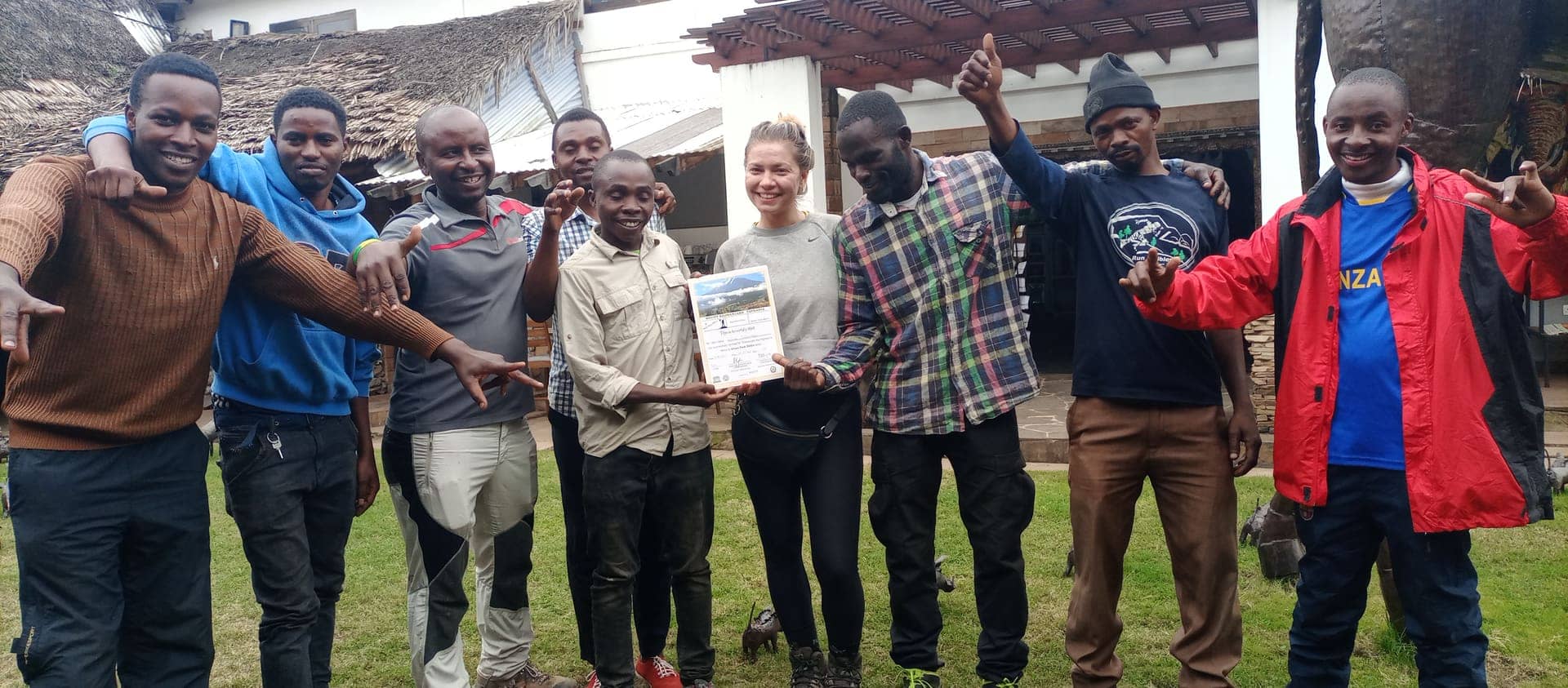 Guides and a guest celebrating with a summit certificate