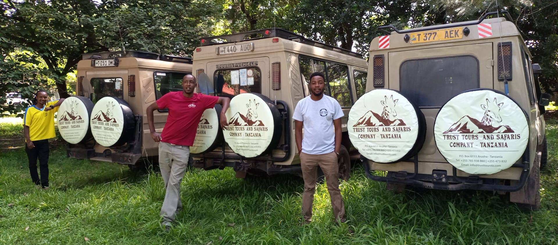 Three Trust Tours guides with the branded Land Cruiser fleet